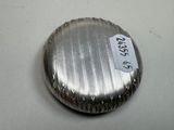 a silver pill case with a tag on it