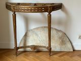 a small table with a marble top on a wooden floor