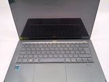 a silver laptop with a black keyboard on a white surface