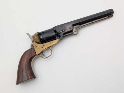 a close up of a revolver on a white surface