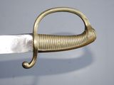 a close up of a gold and silver sword with a handle