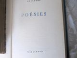 a book open on a bed with a white sheet