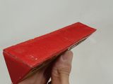 a person holding a red piece of paper in their hand