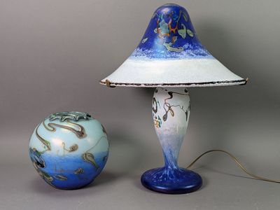 a lamp that is next to a ball on a table