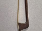 a small wooden bow on a white surface