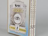 two books in a box on a white surface with a gray background