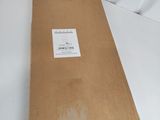 a brown box with a sticker on it sitting on a white surface