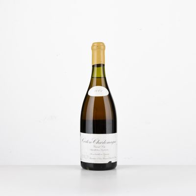 a bottle of wine sitting on top of a white table
