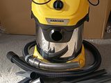 a yellow vacuum that is on the floor next to a brown box