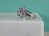 a close up of a diamond ring sitting on top of a marble block