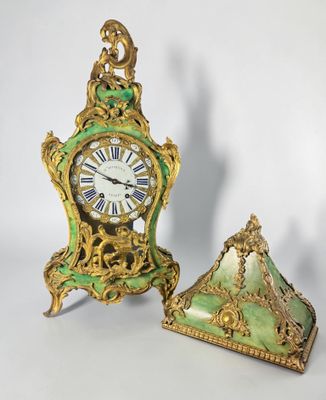 two clocks that are sitting next to each other on a table