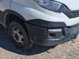 a white van that is parked in the gravel