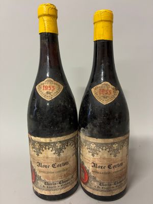 two bottles of wine sitting next to each other on a table
