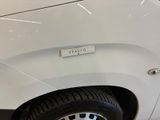 a close up of a white truck with a sticker on it ' s side