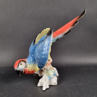 a figurine of a parrot sitting on top of a table