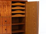 an image of a wooden cabinet with drawers and shelves