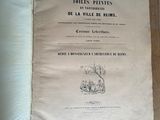 un vieux livre posé par terre, avec l'image d'un chat