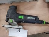 a black and green electric sander on a wooden table