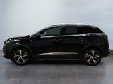 the black suv is parked in a room with a white wall