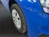 a close up of a blue car parked in a parking lot