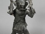 statue of a man holding a knife and a bottle in his hand
