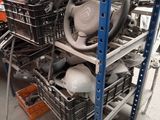a pile of assorted items on a shelf in a garage