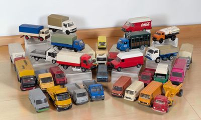 a lot of toy trucks that are on the floor