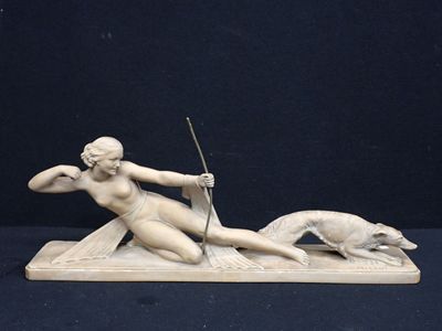 statue of a woman with a whip and a dog on a black background