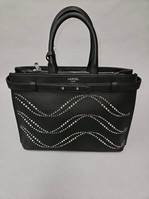 a black handbag with silver studding on the handle