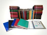 a lot of books stacked on top of each other