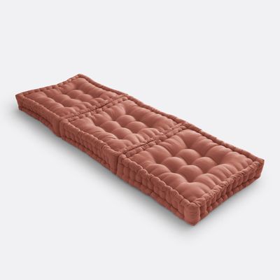 un matelas rose posé sur une surface blanche