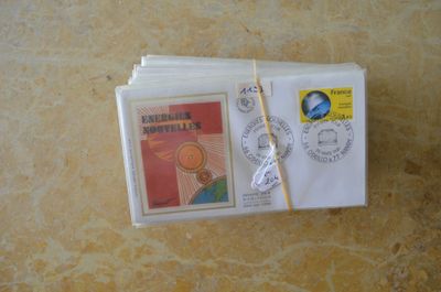une pile d'enveloppes posée sur une table, avec des timbres
