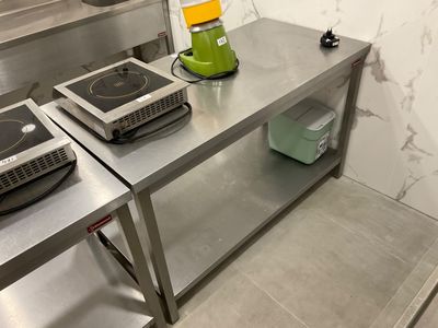 stainless steel counter top with two burners and a blender on top of it
