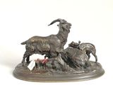 a statue of a goat and two goats in a field