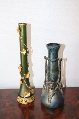 two vases that are sitting on a table