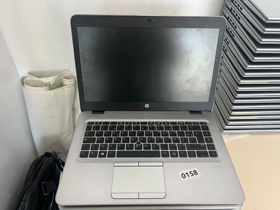 a laptop computer sitting on top of a stack of books