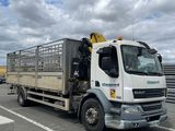 a truck that is driving down the road in the day