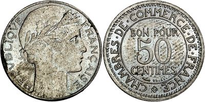 a silver coin with a woman ' s head on it