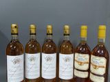 six bouteilles de vin sont alignées dans une rangée