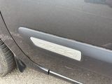 a close up of a car door with a number plate on it