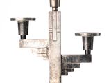 a silver metal candle holder with two candles on it