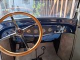 a steering wheel and dashboard of an old car