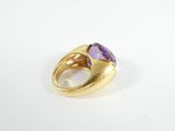 an image of a gold and amethorate ring with a purple stone