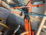 a laptop sitting on a tripod next to a pile of tools