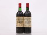 two bottles of wine sitting on top of a table next to each other