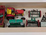 a box that has a bunch of toy farm equipment in it
