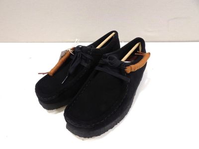 black sued shoes with a bow on the side of them