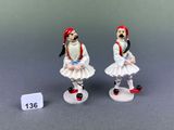 two figurines of a man and a woman dressed in traditional clothing