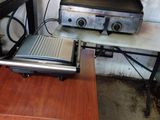 a laptop sitting on a table next to a grill