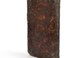 an old book on a white surface with a white background